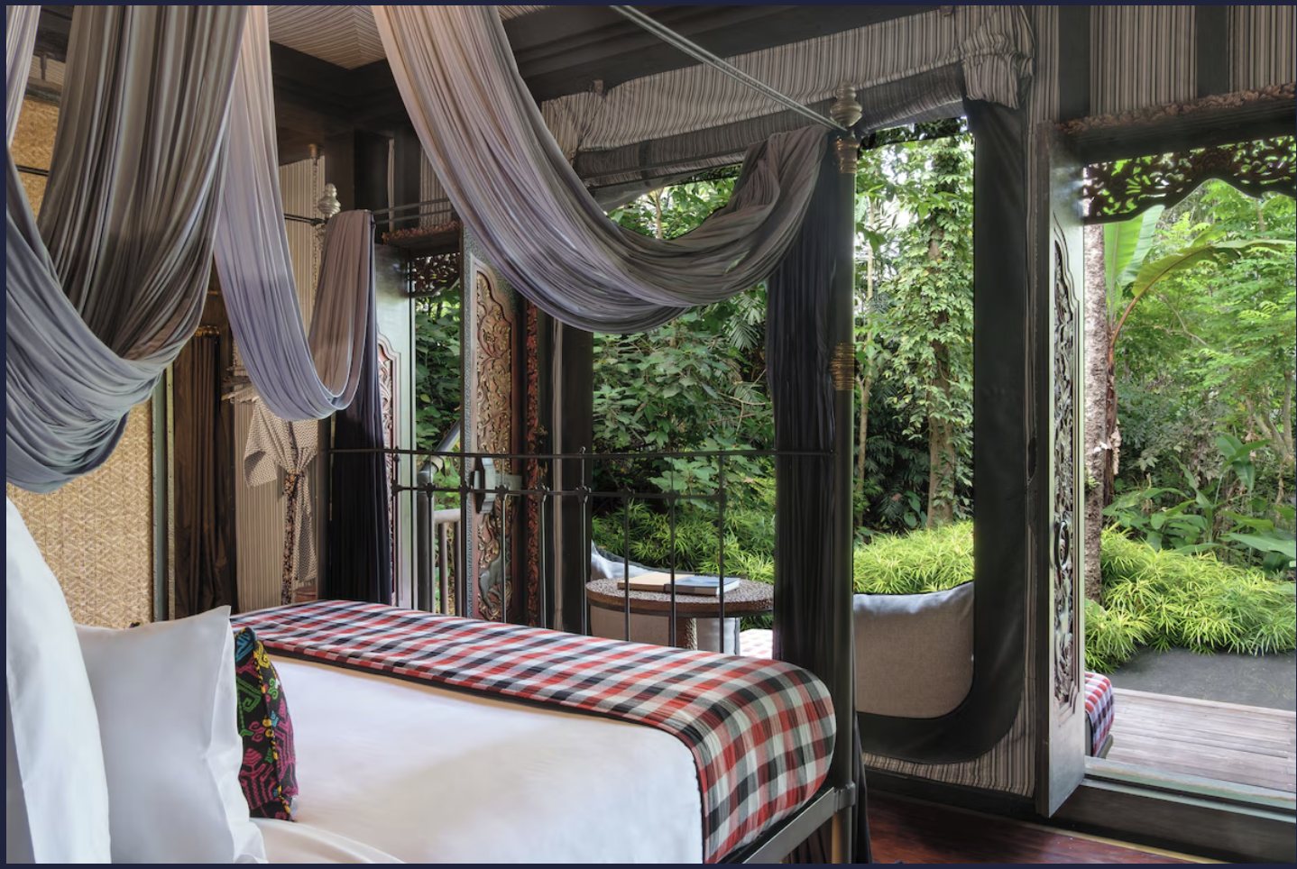 Canopied bedroom opening onto the rainforest at Capella Ubud